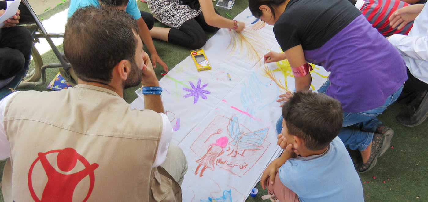 On World Refugee Day we asked children taking part in events at CFS (Child Friendly Space) in Erbil governorate to reflect on the word peace and what it means for them. Activities included theatrical performances, paintings and releasing balloons with wishes and messages of peace on them In the CFS at Qushtapa refugee camp children sit together and draw images of peace. Doves, trees and children holding hands are recurring themes