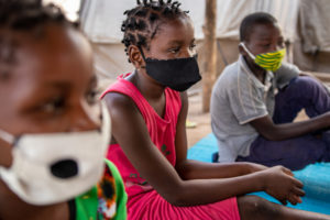 Children from Cabo Delgado sitting and listening.