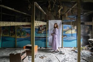 Nadiya*, 16, poses for a portrait at her damaged school outside of Kyiv (Oleksandr Khomenko/Save the Children)