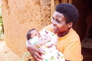 Sarah*, 31, with her third baby, born healthy due to a C-section. Photo credit: Thacien Biziyaremye/Save the Children.