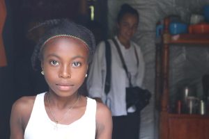 Young girl stares into camera.
