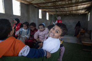 Hassan enjoys learning with his classmates 