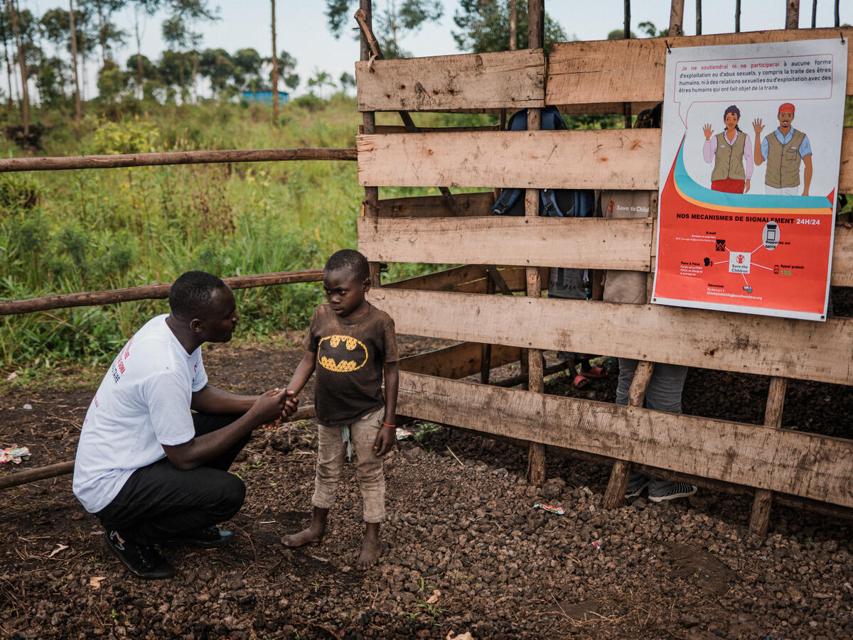 Joseph 10 speaks to partner staff member Justin at the CFS