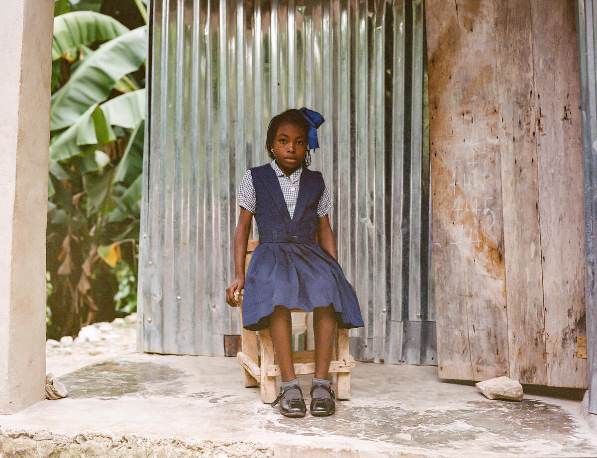 Entha, 10, Edlène's daughter wears her school uniform at home in south west Haiti.