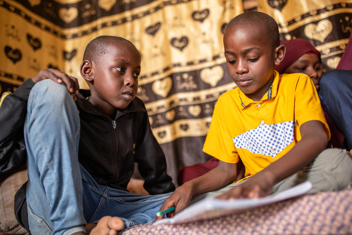 Omar, 7, drawing with his brother